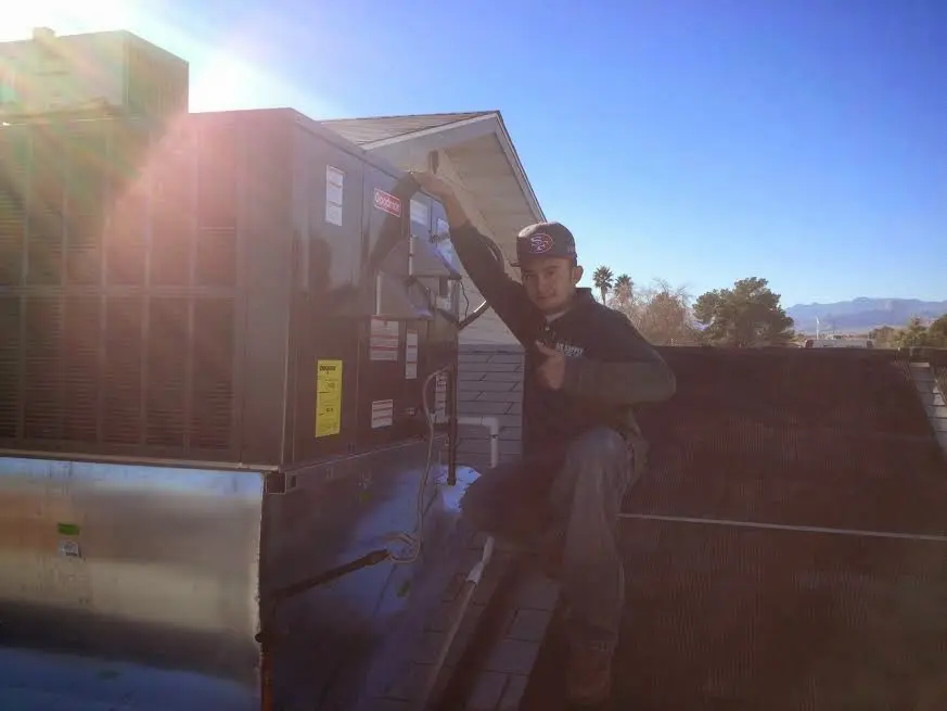 HVAC technician performing Air Duct Repair on a rooftop unit in Wawayanda